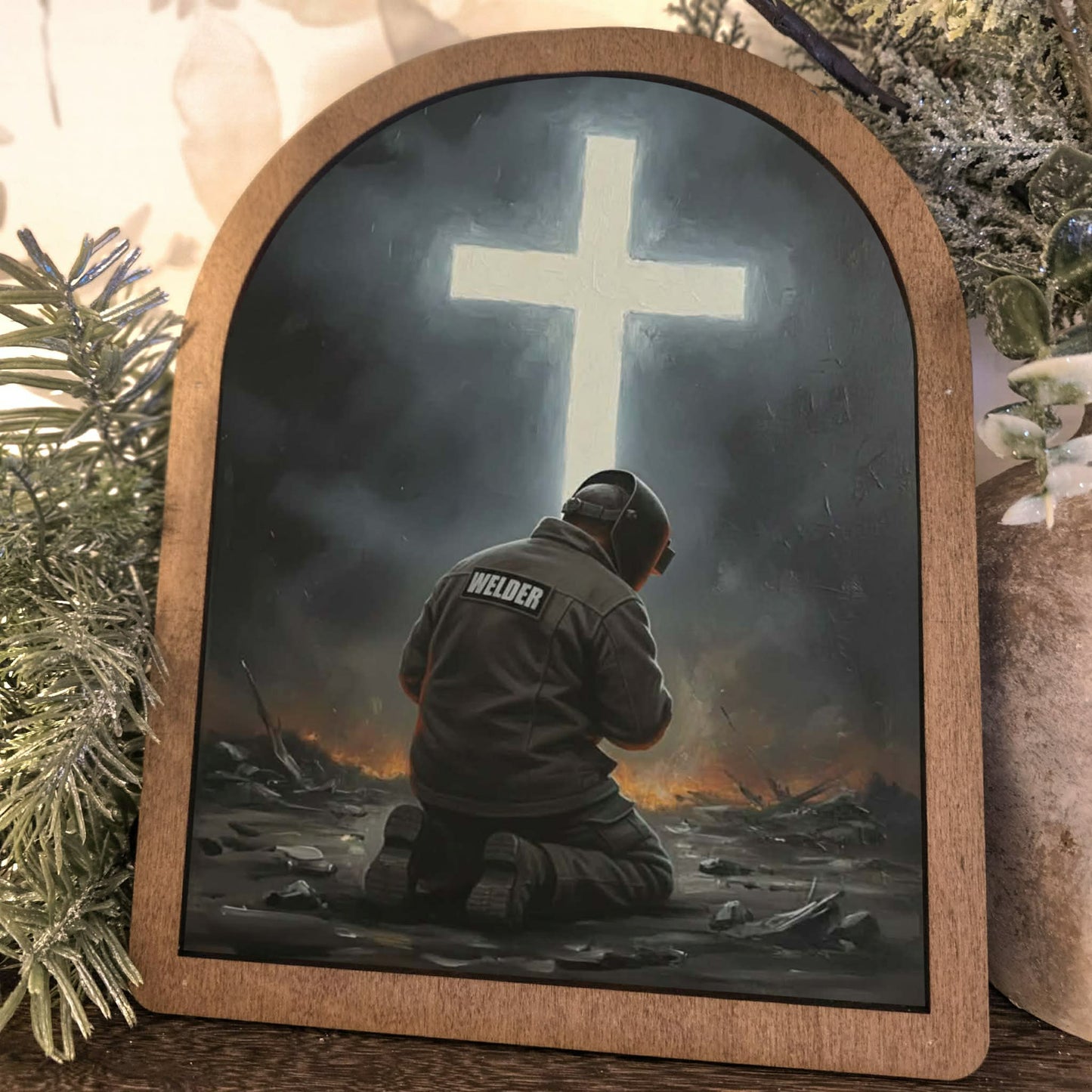 Welder Kneeling Before Cross Framed Art